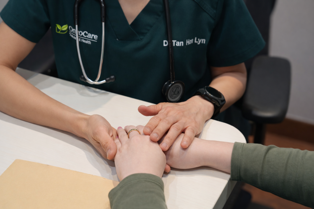 Doctor holding patients hands
